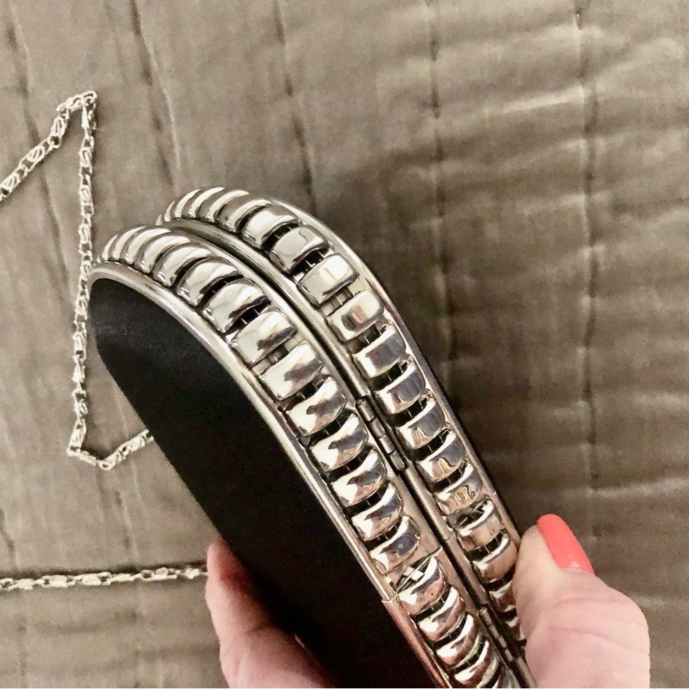 STEVE MADDEN tiny cross body with long chain. Body is a black satiny hard case
